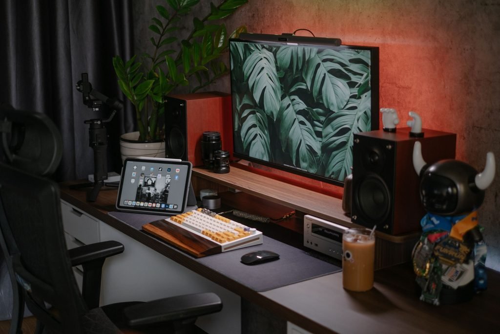 Modern home office desk setup with a large monitor and organized workspace